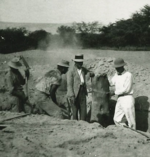 Black and white photo of Farabee and his team excavating at a site.