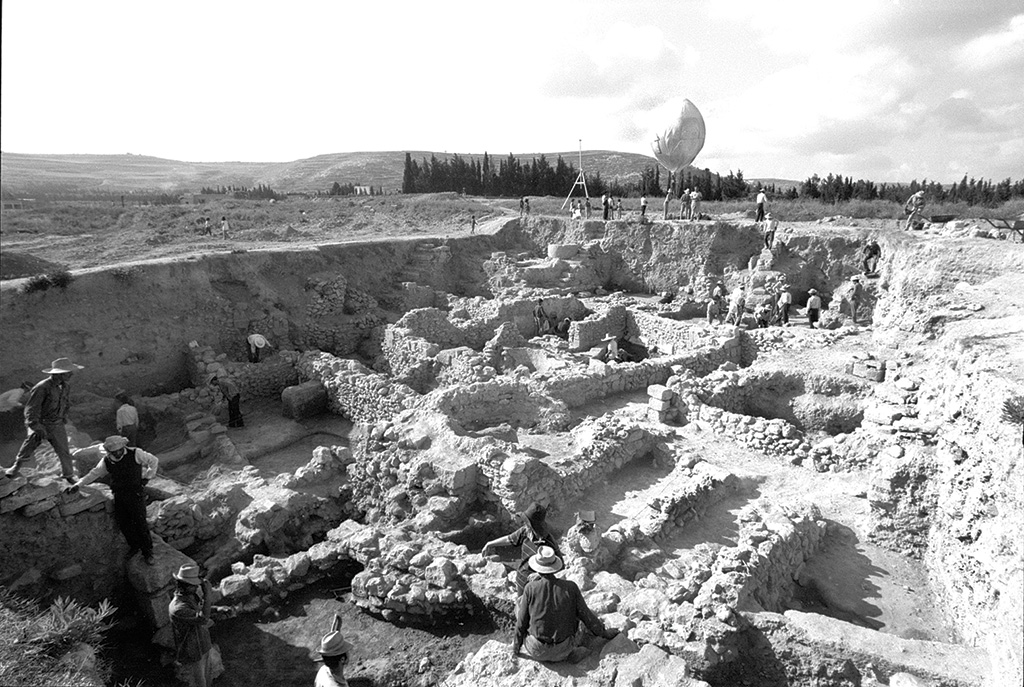 A large balloon in the background of an excavation site, with workers in the foreground.