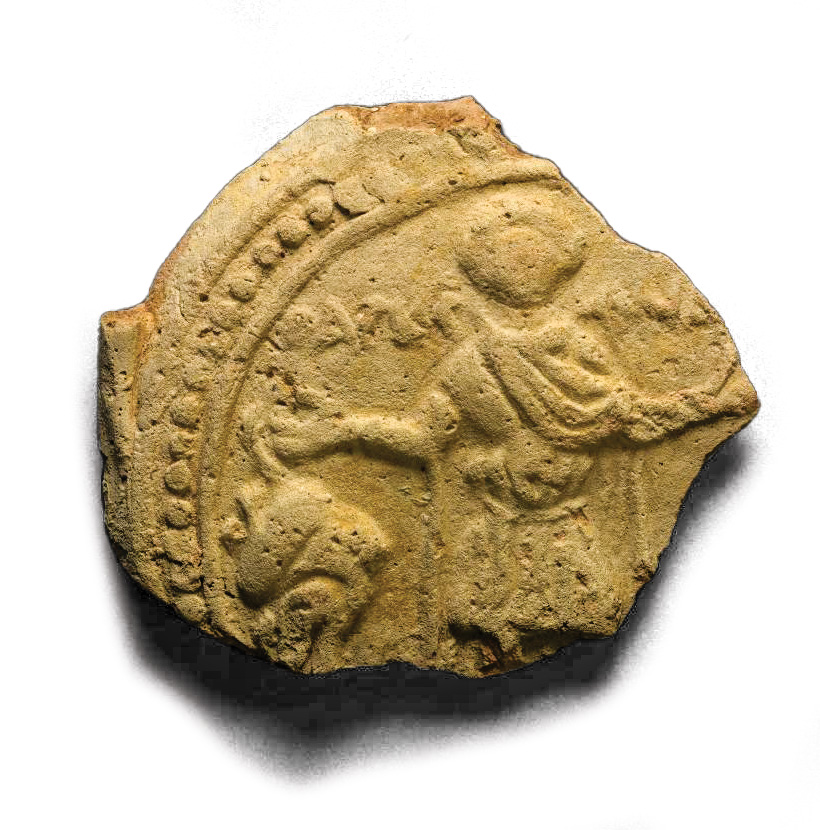 A fragment of a flask with an relief image of a saint.