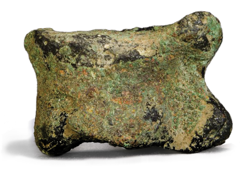 A bronze amulet shaped like an animal's knuckle bone.