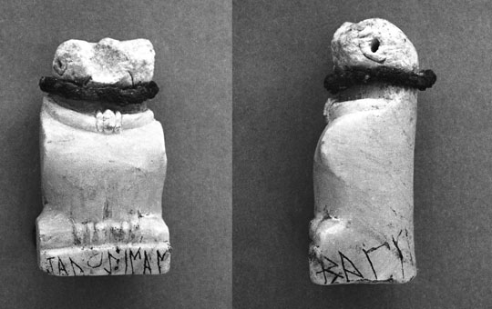 A small animal figurine with an inscription around the base, front and side views.