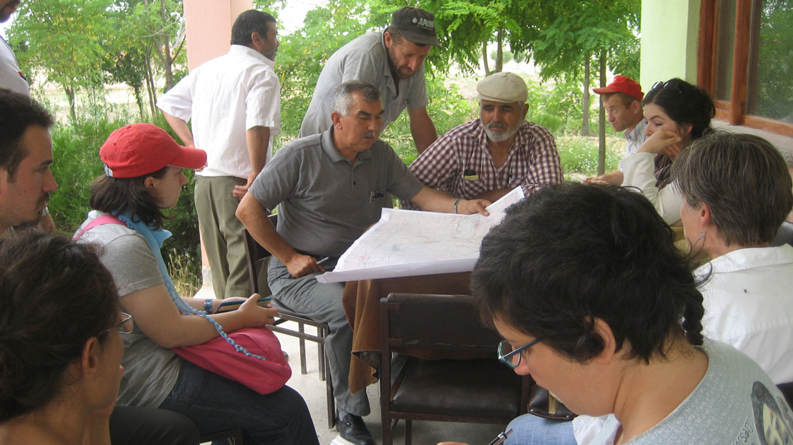 A group of people looking at site plans for Gordion.