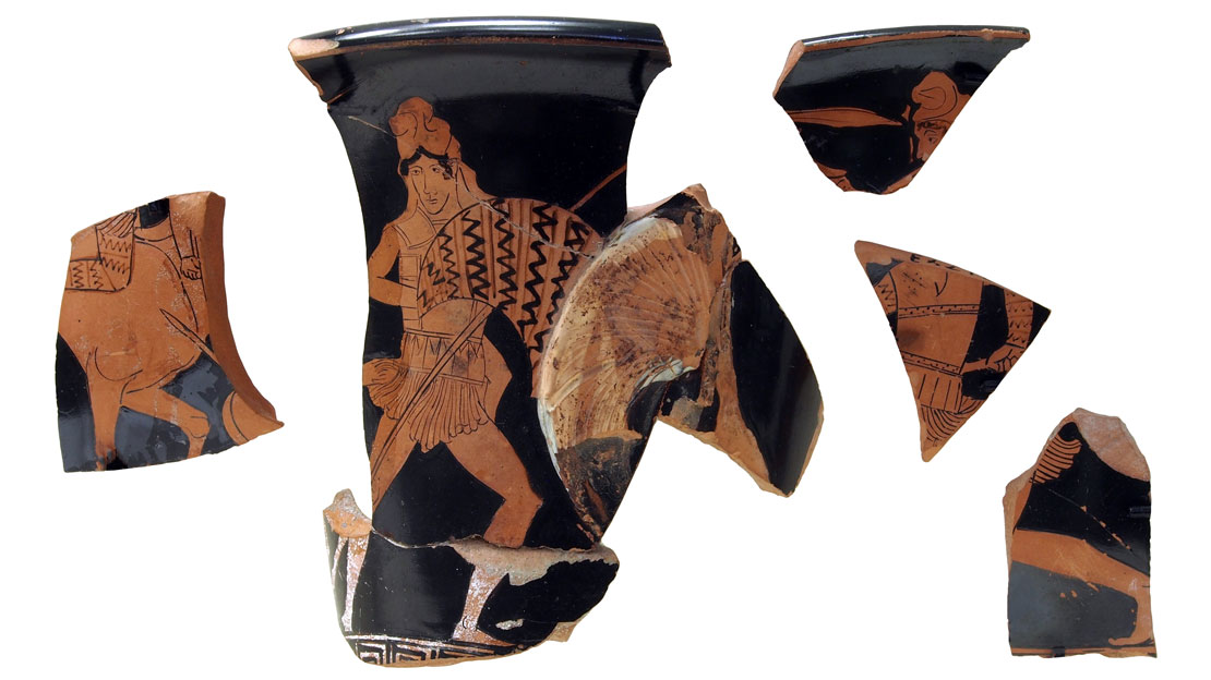 Several painted vase fragments, showing a warrior on a black background.