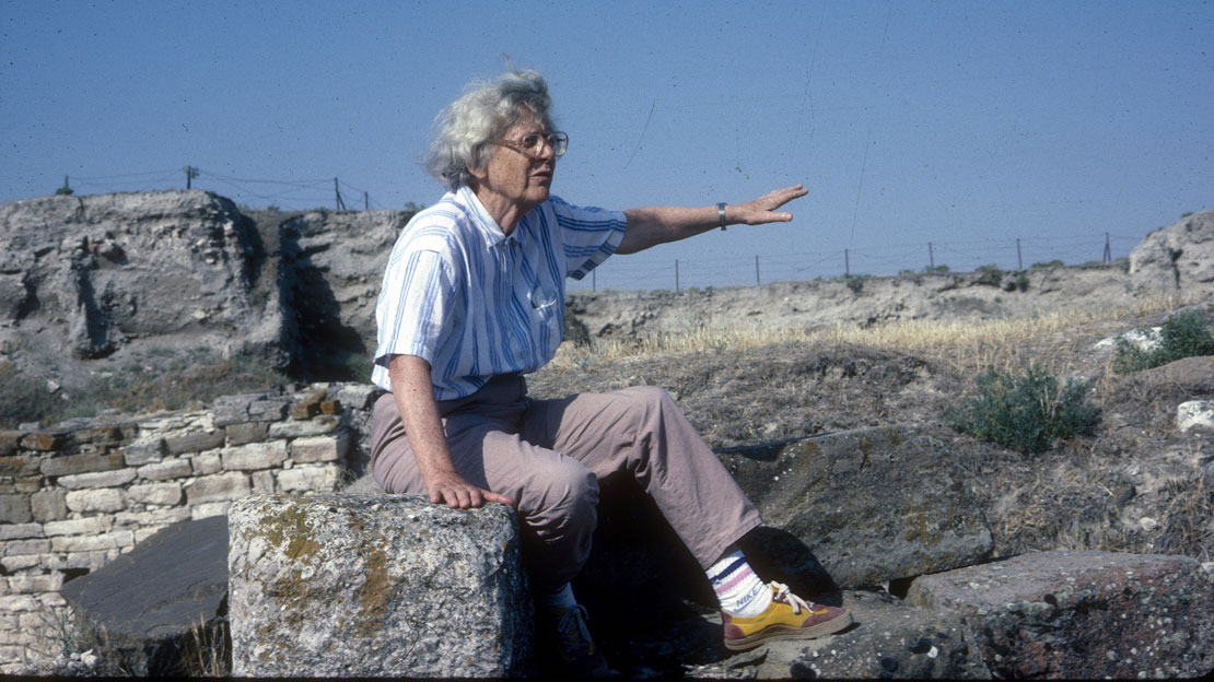 A woman sitting near stone brick walls at Gordion.