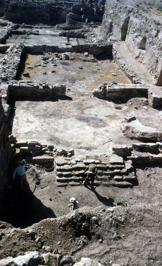 An excavated building foundation with stairs leading to what would have been the entrance.