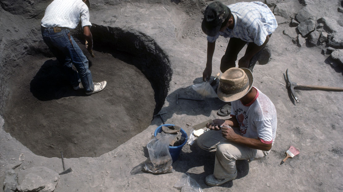 Three excavators at Gordion, working on a cylindrical area.