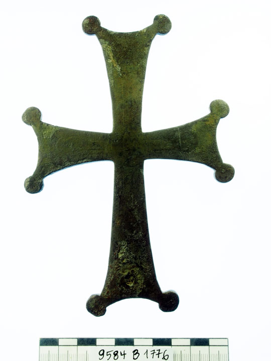 A metal cross with circles at each point.