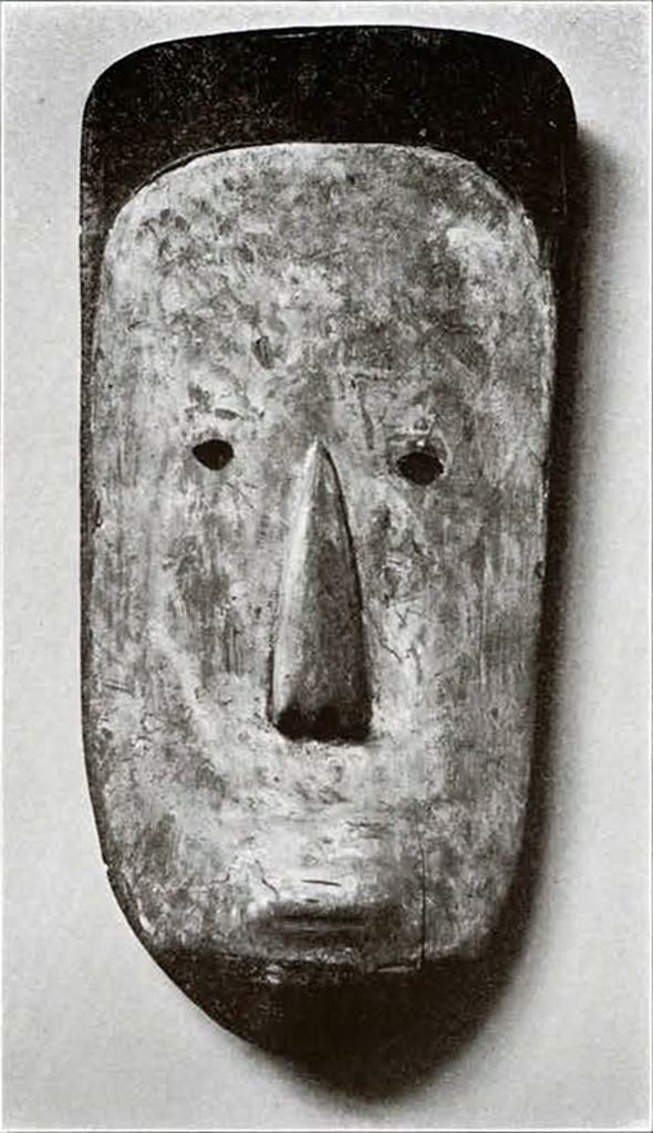 A wooden mask with triangular ornamentation