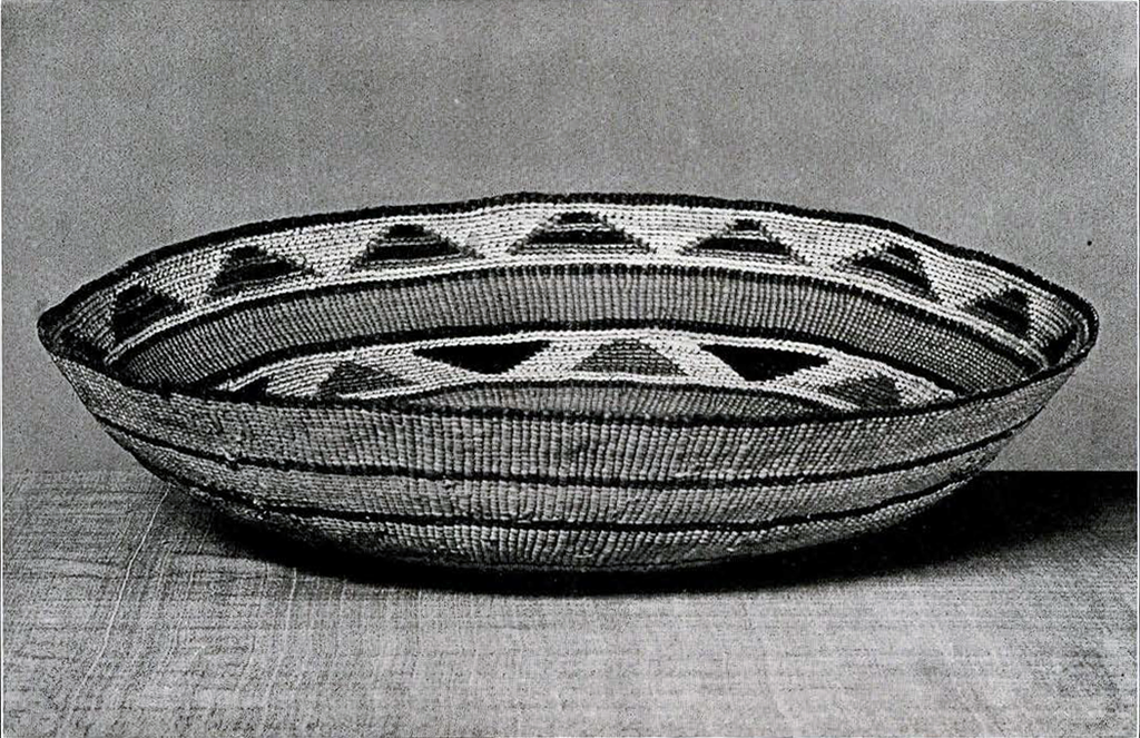 A flat basket with triangular patterns and stripes