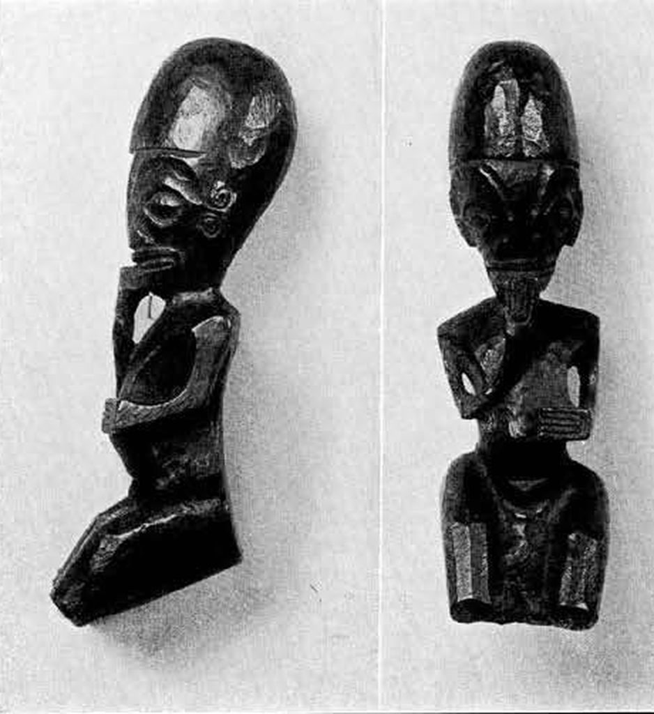carved seated figure from a canoe ornament