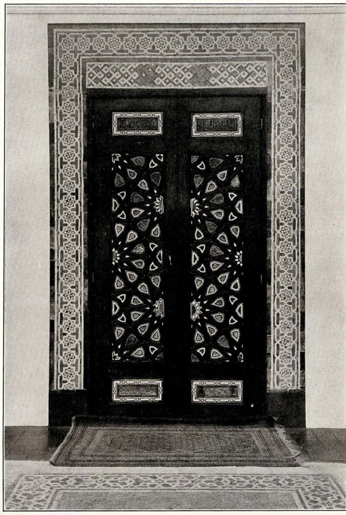Wood door with ivory inlay in kaleidoscope pattern with tile border