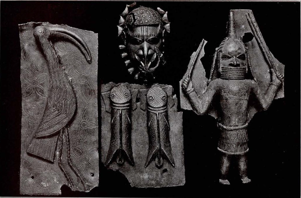 four bronze plaque fragments, showing an ibis, a pair of catfish, a mask, and a figure holding two wands