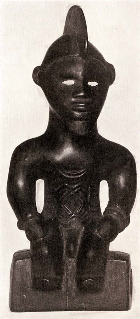 Carved wood seated figure with a crested hair or headpiece, from the front