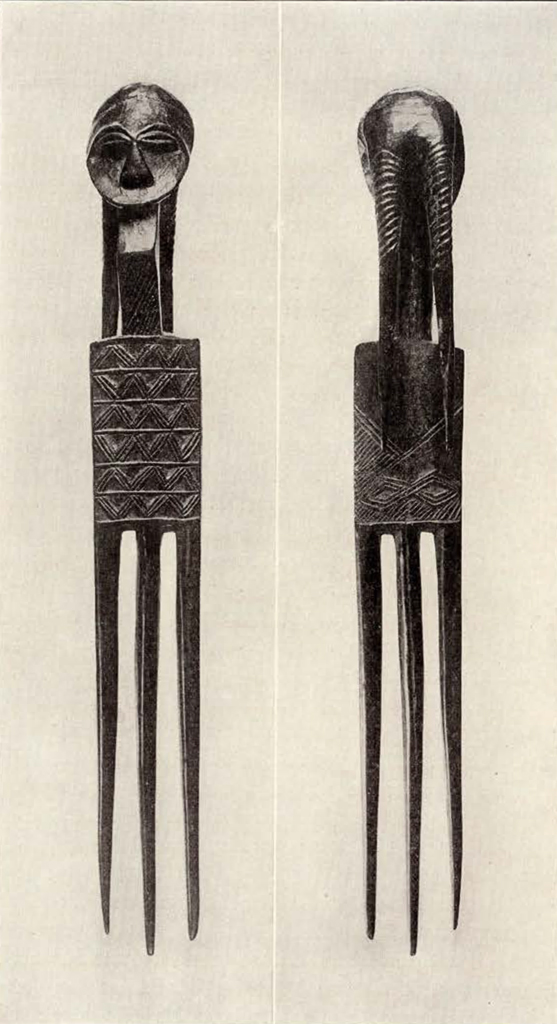 Three pronged hair comb or ornament with a face on the handle, front and back