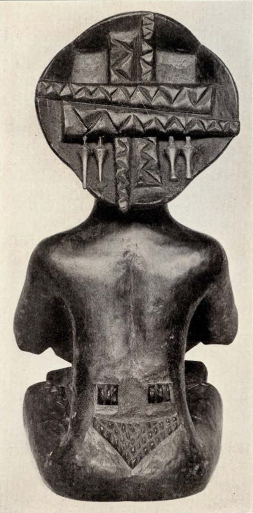 Wood carved seated woman holding a bowl, back view showing designs in the headpiece and on her back