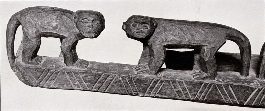 Wood carved door lintel, left side, two monkeys facing each other but heads turned outward