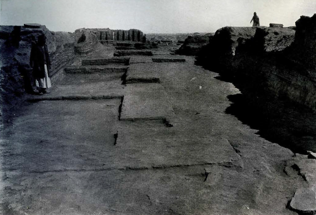 excavated street with divots marking where buildings or stalls once were