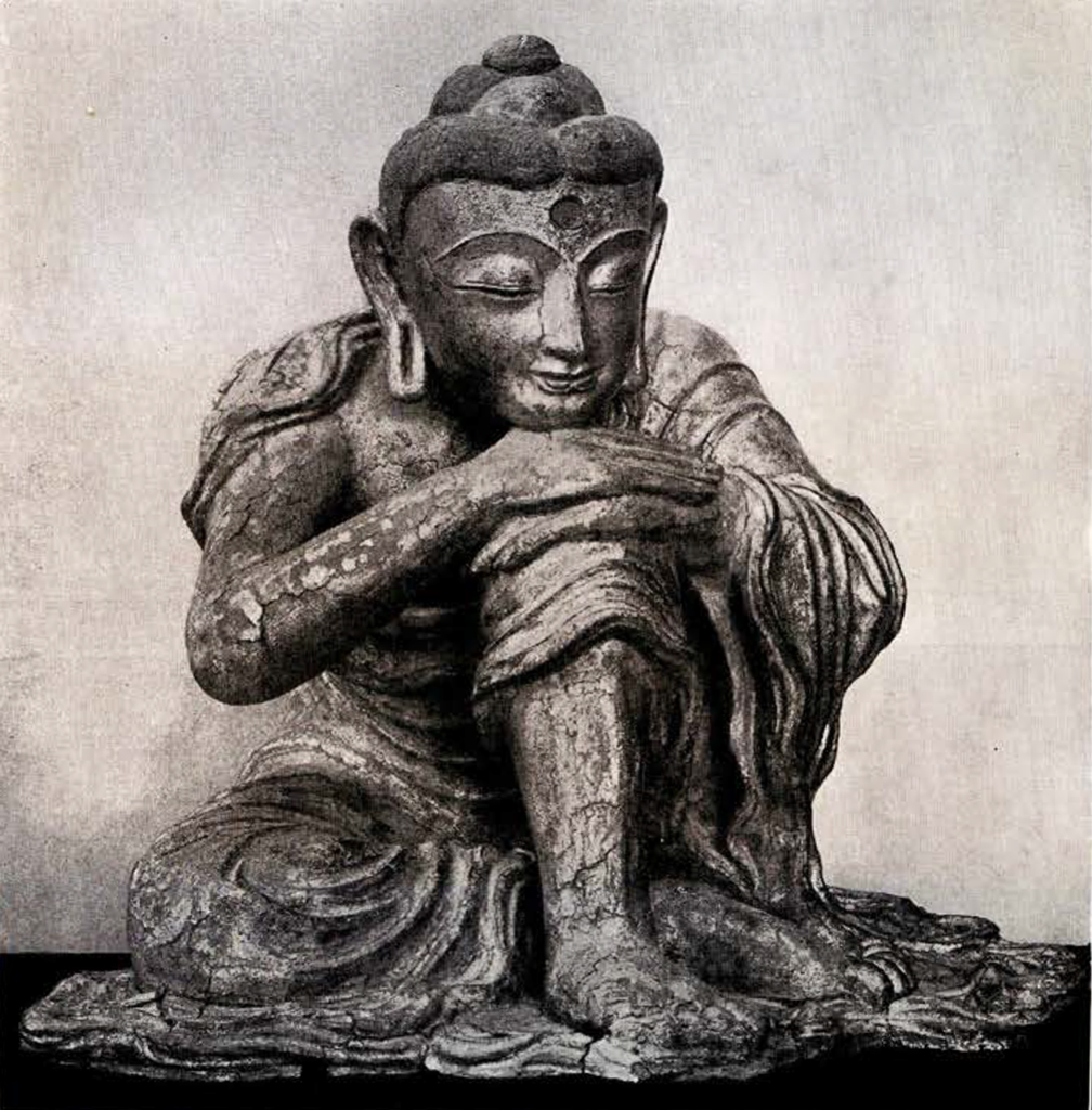 Seated figure of Sakyamuni Buddha in meditation with chin leaning on his hands which are joined over the raised left knee. The other leg is bent horizontally in front of the figure.