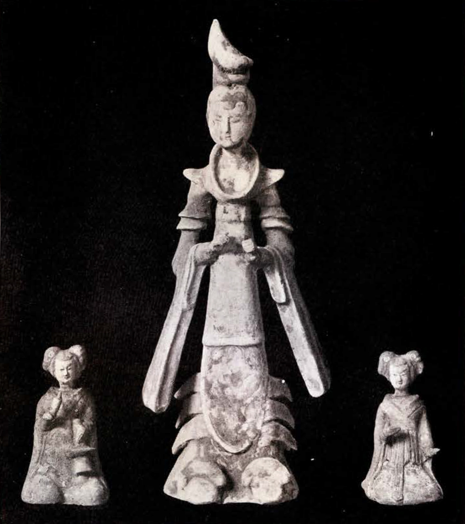 Three figurines, a tall princess in the middle and her two much smaller seated attendants on either side
