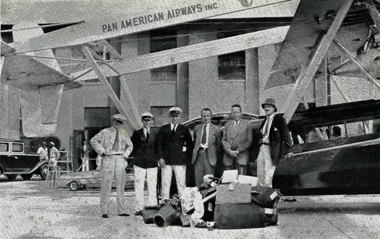 Portrait of men on the aerial expedition in front of their plane