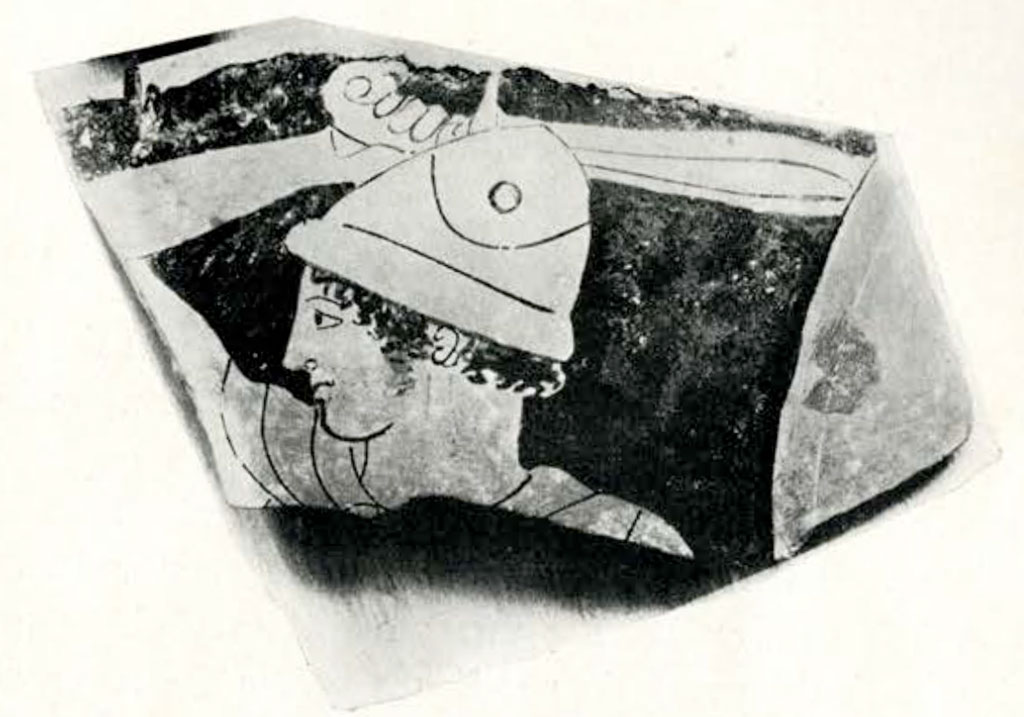 Fragment of a vase showing a warriors head wearing a helmet, and holding a sword aloft