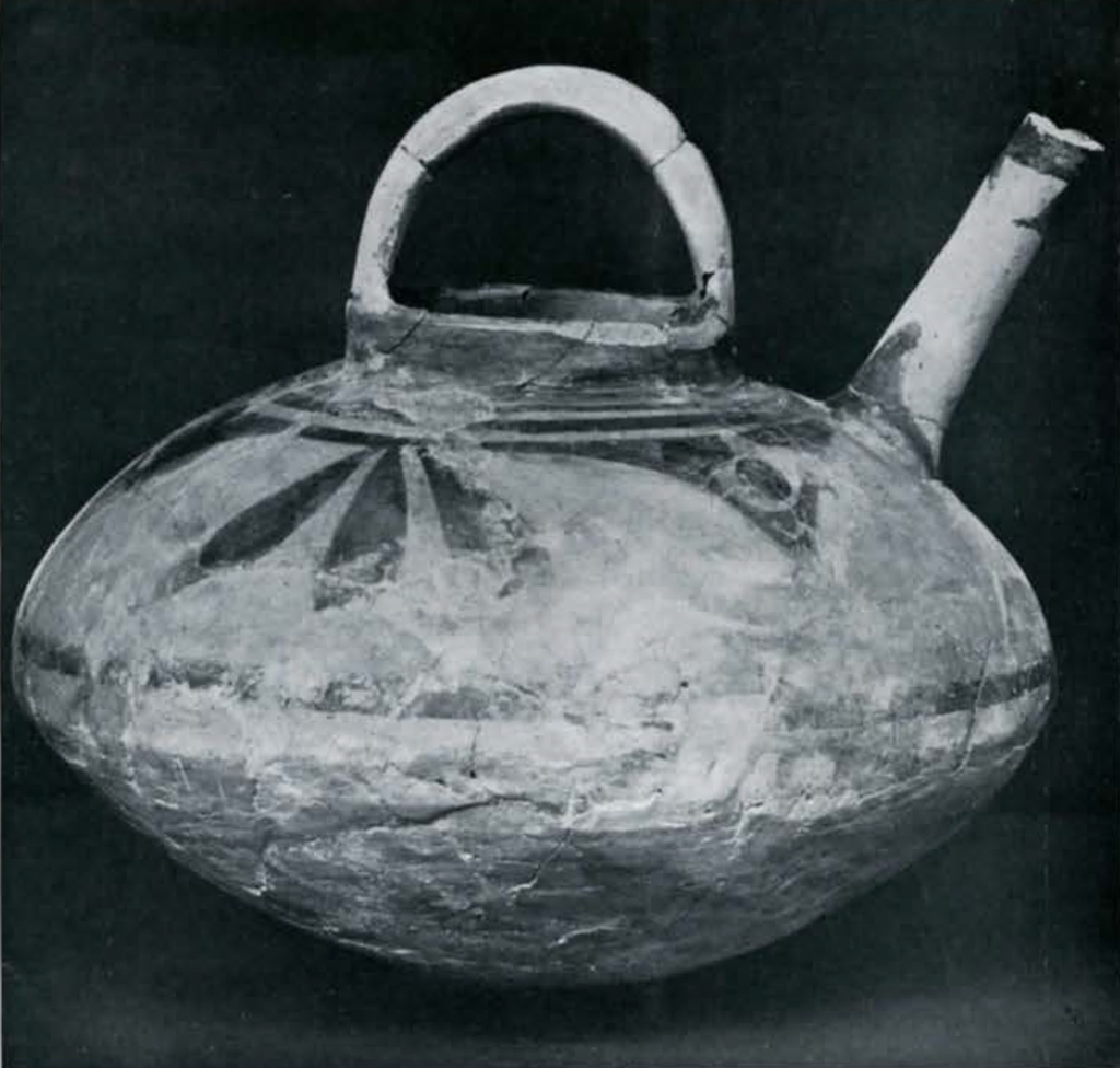 A teapot or spouted vessel with pained decor around the top