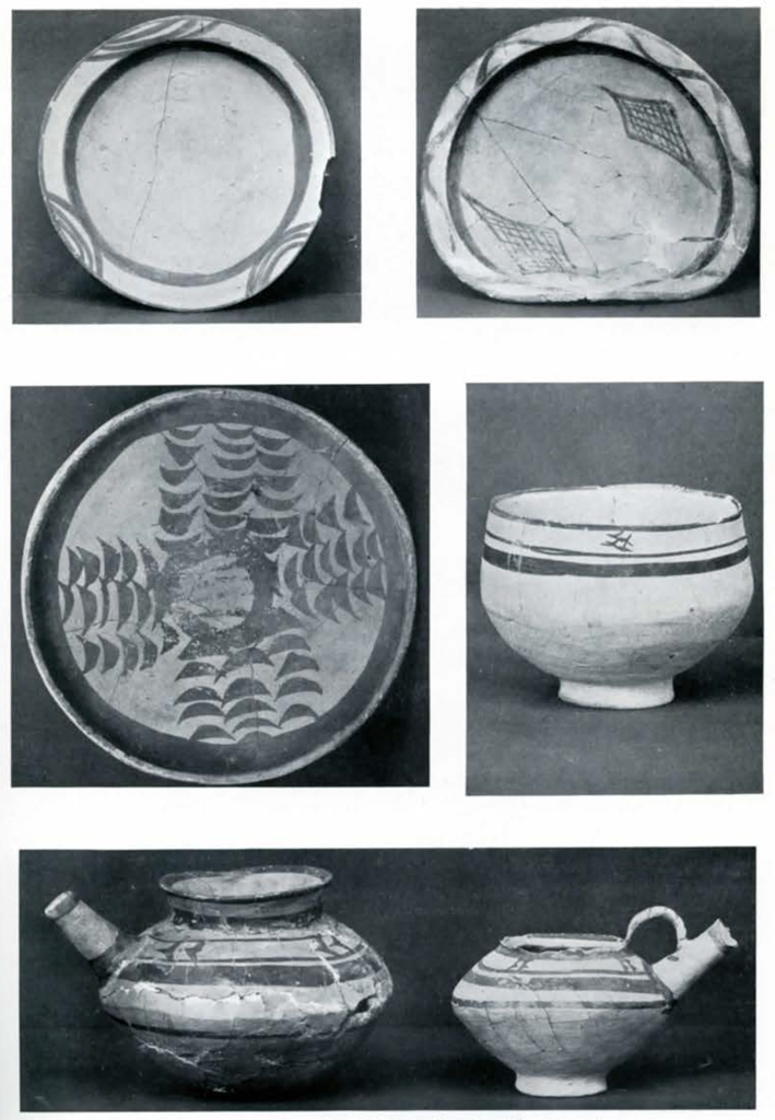 Several pieces of painted pottery including plates, bowls, and spouted pots