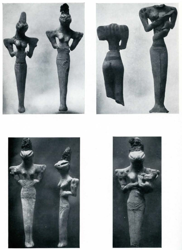 Several figurines with elongated faces and eyes, and broad shoulders, some of which are nursing infants