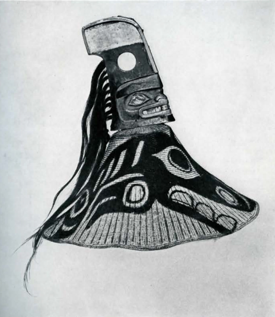Woven hat with whale design and crested face figure with hair on top