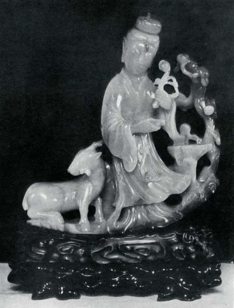 Jade figure of a woman next to a small deer