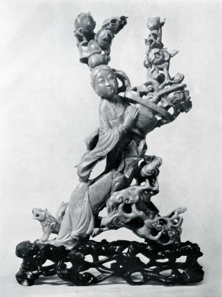Figure of a female fair holding a basket of flowers and with flowers on top of her head