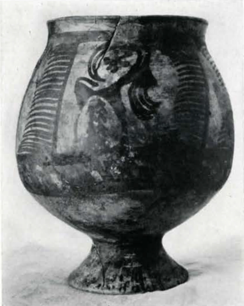 a footed jar with a round bowl and flared lip with an ibex on it