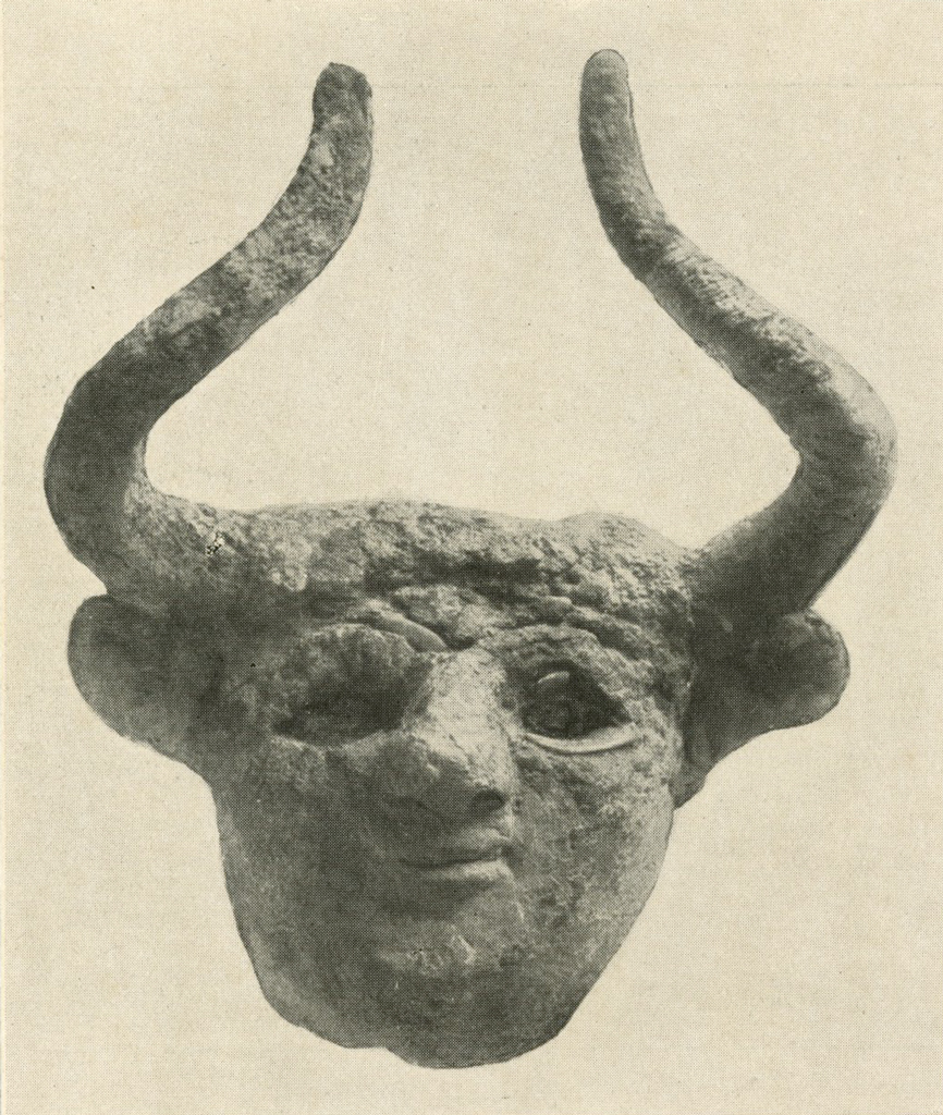 Head with horns and recessed eyes