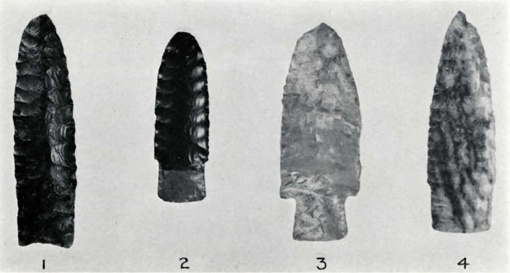 four carved stone spear or arrow points