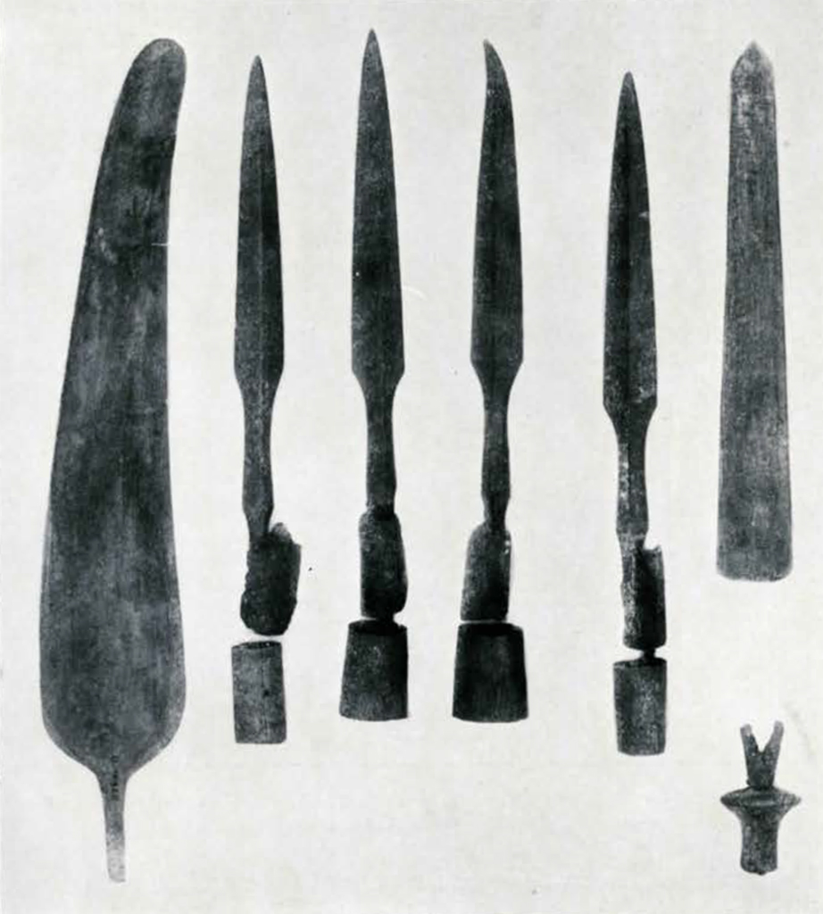 Several spear heads, a feather shaped saw, and a pronged piece
