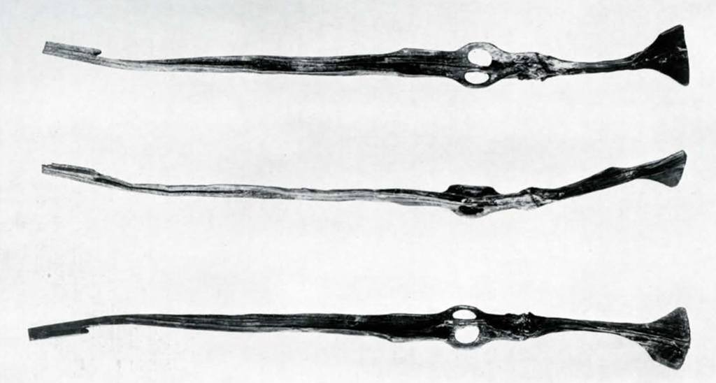 Top, bottom, and side view of a wood spearthrower