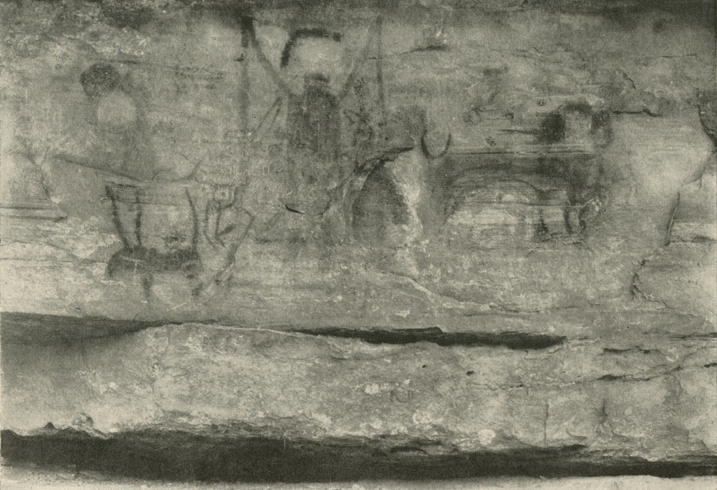 Paintings, one of a human figure with arms raised, on a rock face