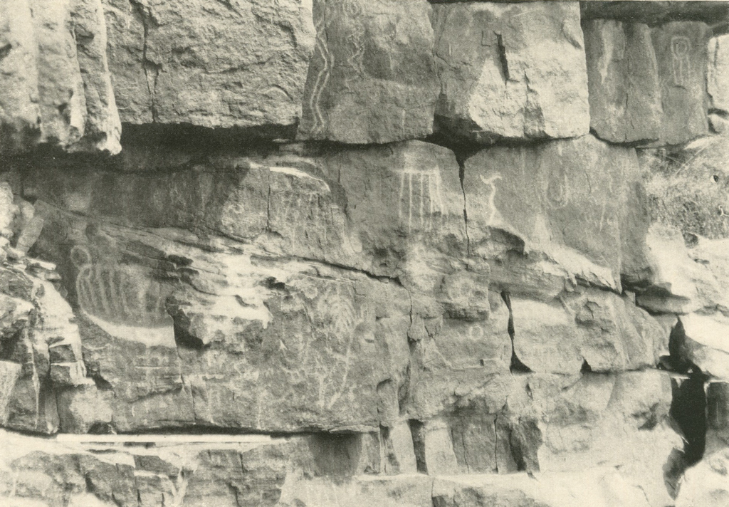 Etched petroglyphs on several rocks together