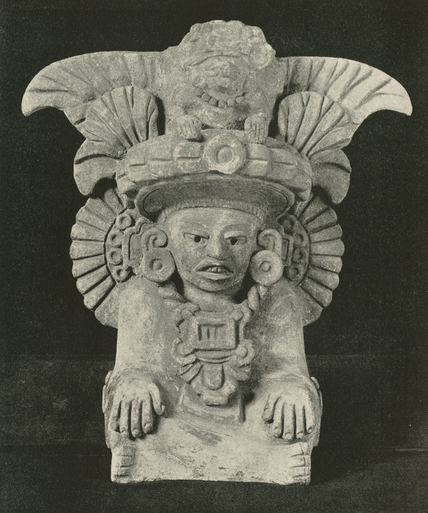 Effigy urn of a seated figure with large headdress, hands on knees