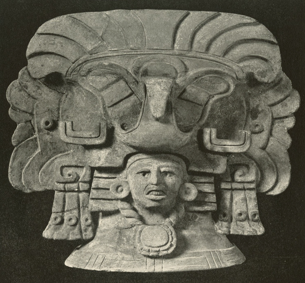 Effigy urn of a head with an enormous headpiece