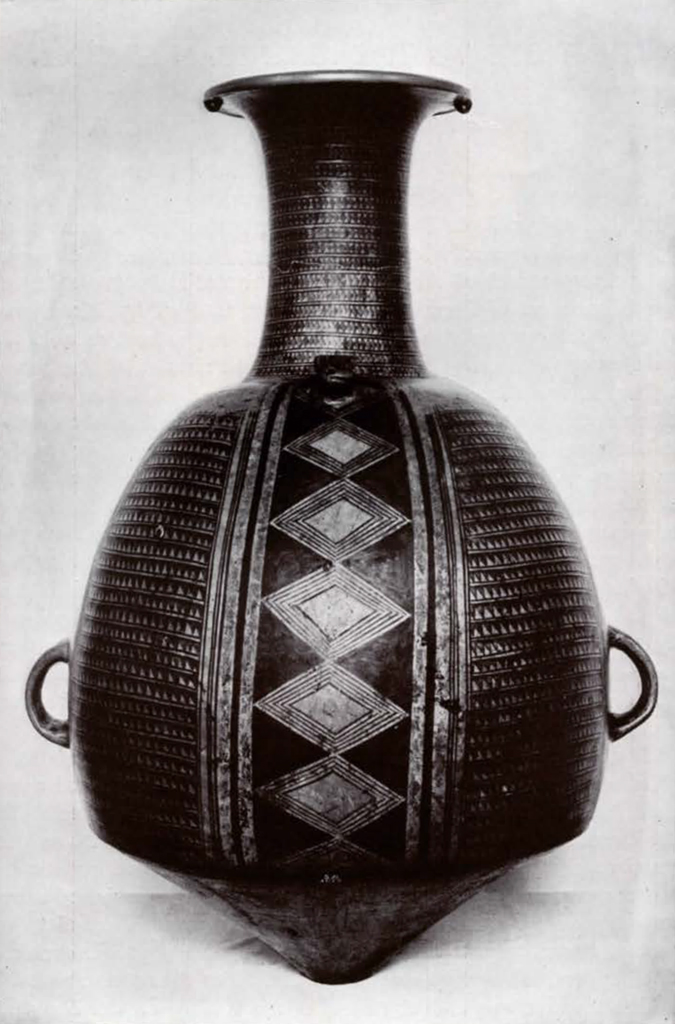 Red aryballus vase with two small handles on the body and tall neck, red vertical diamond design