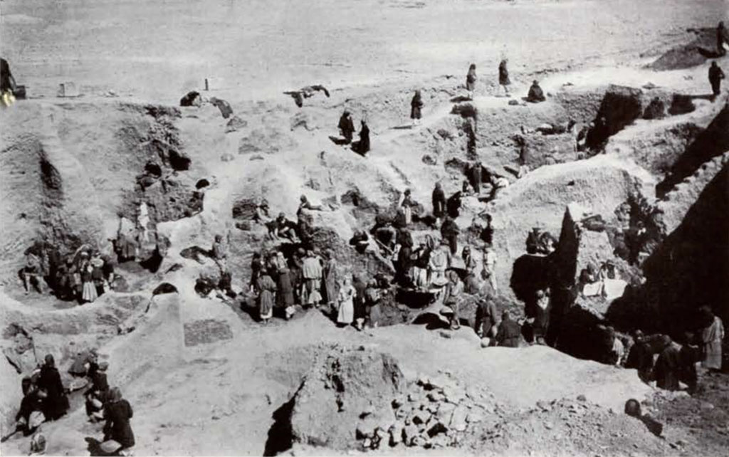 Men working to excavated a cemetery on several levels