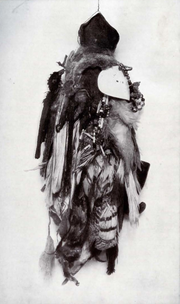 Bag decorated with feathers, fur, and beads hanging off
