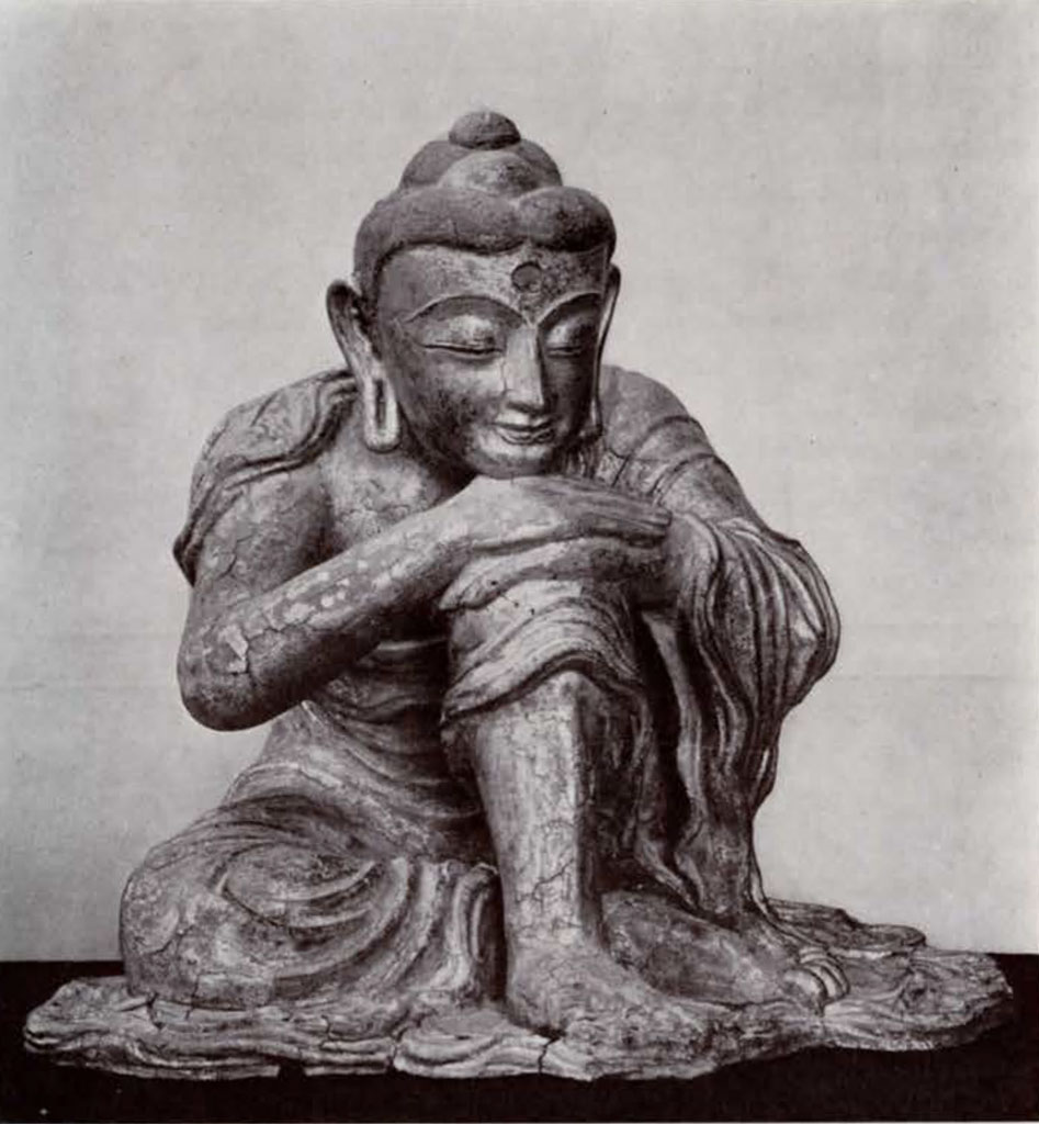 Statue of the seated Sakyamuni Buddha with chin resting on hands which rest on one upraised knee
