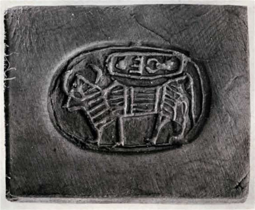 An impression of an oval seal with a bull and cartouche