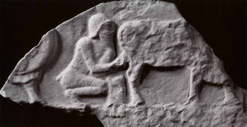 Fragment of a stela showing a man milking a cow