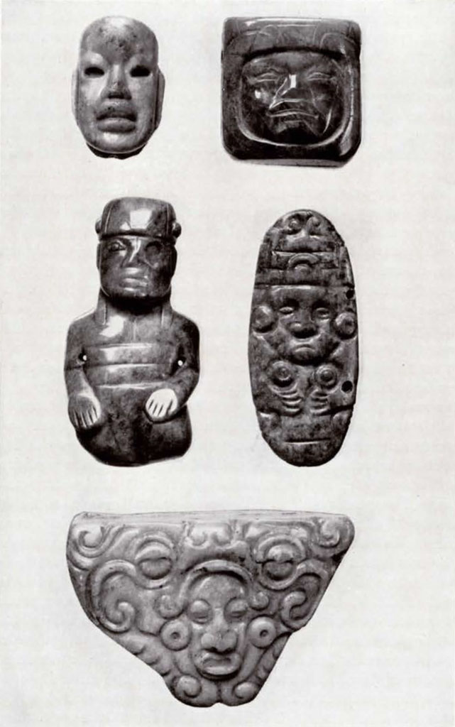 Five small jade objects with faces on them