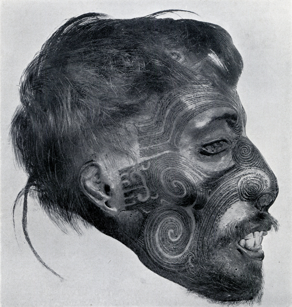 Profile of a head with intricate swirling facial tatoos