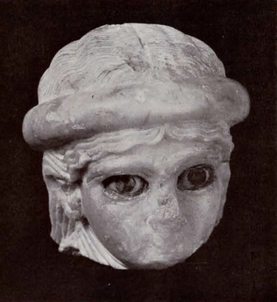 Head of a woman with headband and inlaid eyes