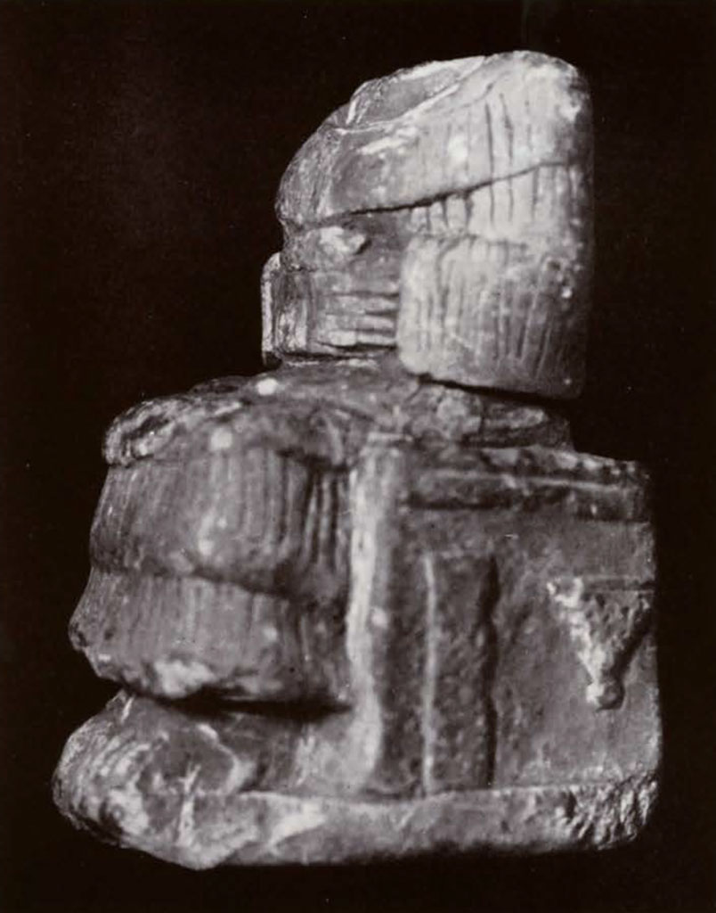 Headless seated goddess statue in tiered dress